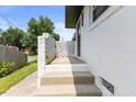 Brick patterned side porch and steps leading to a white brick home exterior at 1020 Benning St, Durham, NC 27703