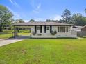 Beautiful one-story house with freshly cut lawn, carport, and minimalist landscaping at 1020 Benning St, Durham, NC 27703