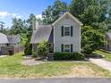 Inviting home exterior with green shutters, lush landscaping and a well-manicured lawn at 519 High Ridge Dr, Durham, NC 27707