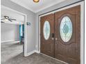 Inviting entryway featuring a beautiful double door with decorative glass inserts and tile flooring at 5209 Amsterdam Pl, Raleigh, NC 27606