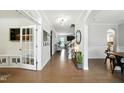Elegant foyer featuring hardwood floors, arched doorways, and decorative moldings creating a grand entrance at 5716 Sarcelle St, Holly Springs, NC 27540