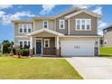 Two-story home featuring a blue front door and an attached two-car garage with verdant lawn at 812 Teal Lake Dr, Holly Springs, NC 27540