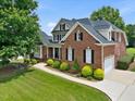 Spacious home with attached garage, manicured lawn, and mature trees in a desirable neighborhood at 9045 Chelsea Dr, Raleigh, NC 27603
