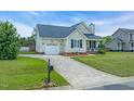 Well-maintained one story home with attached garage, long driveway and attractive landscaping at 104 Roscommon Ln, Clayton, NC 27520