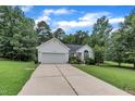 Charming home featuring a manicured lawn, attached garage, and well-maintained landscaping at 2003 Zbonack Ct, Creedmoor, NC 27522