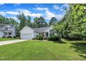 Home featuring a manicured lawn, attached garage, and well-maintained landscaping at 2003 Zbonack Ct, Creedmoor, NC 27522