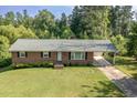 Well-maintained brick home with a covered parking area and a neatly kept lawn at 3603 Grimes Ave, Durham, NC 27703