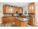 Spacious kitchen with an island, stainless steel appliances and plenty of cabinet space at 701 Oakhall Dr, Holly Springs, NC 27540