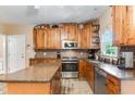 Well-equipped kitchen with wooden cabinets, an island, and stainless steel appliances at 701 Oakhall Dr, Holly Springs, NC 27540