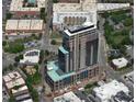 Aerial view of high-rise building showing the building within the surrounding neighborhood, streets, and parking areas at 400 W Main St # 2007, Durham, NC 27701
