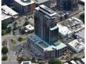 Aerial view of high-rise building showing the building within the surrounding neighborhood, streets, and parking areas at 400 W Main St # 2007, Durham, NC 27701