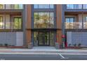 Modern apartment building entrance with glass doors, side foliage, and FDC connection at 600 N Roxboro St # 41, Durham, NC 27701