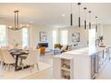 Bright, open-concept living and dining area features modern lighting and luxury furnishings at 600 N Roxboro St # 41, Durham, NC 27701