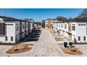 Street view featuring townhomes with modern architecture and a brick-paved road at 610 Walnut Hts Dr # 102, Raleigh, NC 27610