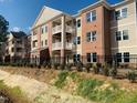 Apartment building exterior with balconies and a fenced backyard at 403 Weather Ridge Ln # 42, Cary, NC 27513