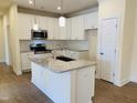 Modern kitchen with white cabinets, granite counters, and island at 403 Weather Ridge Ln # 42, Cary, NC 27513