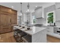 Spacious kitchen featuring a large island with seating, modern appliances, white subway tile, and wood cabinetry at 2601 Mayview Rd, Raleigh, NC 27607