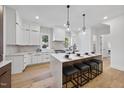 Modern kitchen with island, white cabinets, and marble countertops at 2601 Mayview Rd, Raleigh, NC 27607