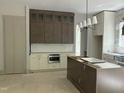 Modern kitchen with custom cabinetry, stainless steel appliances, and a center island for food preparation at 57 Hazelwood, Pittsboro, NC 27312