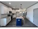 Open kitchen with white cabinets, granite countertops, and a center island at 345 Maidenhair Pl, Clayton, NC 27520