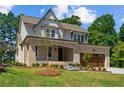 Two-story home with brick exterior, landscaping, and a two-car garage at 405 Bridgewater Dr, Sanford, NC 27330