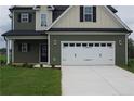Charming two-story home with a two-car garage and a well-manicured lawn at 115 Grinnel Loop, Sanford, NC 27332