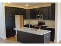 Modern kitchen with stainless steel appliances and a spacious island at 115 Grinnel Loop, Sanford, NC 27332