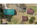 An aerial view of the house with outbuildings, multiple parking spaces and a large green lawn at 5027 Lake Willett Rd, Sanford, NC 27332