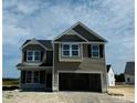 Two-story house with gray siding, a two-car garage, and landscaping at 30 Willow Walk (Lot 460) Way, Cameron, NC 28326