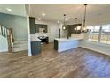Modern kitchen with sleek gray cabinetry, white countertops, stainless steel appliances, and new hardwood floors at 35 Fort Mcclary Ct, Cameron, NC 28326
