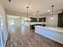 Open concept featuring modern kitchen with island, stainless steel appliances, and inviting living area at 35 Fort Mcclary Ct, Cameron, NC 28326