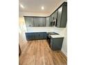 Modern kitchen with gray cabinets, white quartz countertops, and stainless steel appliances at 35 Fort Mcclary Ct, Cameron, NC 28326