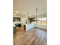 Modern kitchen featuring dark gray cabinets, white countertops, and hardwood floors at 35 Fort Mcclary Ct, Cameron, NC 28326