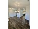 Dining room with hardwood floors and chandelier, open to kitchen at 36 Fort Mcclary Ct, Cameron, NC 28326