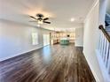 Spacious living room with hardwood floors, ceiling fan, and access to a deck at 36 Fort Mcclary Ct, Cameron, NC 28326