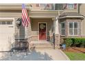 Charming front porch with a red door, stone accents, and black wrought-iron seating at 14 Valley Brook Ln, Spring Lake, NC 28390