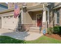 Inviting front entrance with stone accents, American flag, and a cozy bench at 14 Valley Brook Ln, Spring Lake, NC 28390