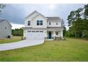 Inviting two-story home with a well-manicured lawn, two-car garage, and classic design at 2937 Lemuel Black Rd, Bunnlevel, NC 28323