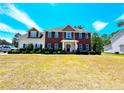 Two-story brick home with a large front yard and mature trees at 11 Antique Ct, Cameron, NC 28326