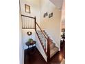 Elegant staircase with a wooden railing and carpeted steps at 11 Antique Ct, Cameron, NC 28326