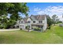 Beautiful two-story home with attached garage, manicured lawn, mature tree, and pleasant curb appeal at 40 Sedgefield Ln, Spring Lake, NC 28390