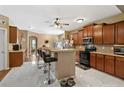 Spacious kitchen with sleek marble floors, granite countertops, dark wood cabinets, and stainless appliances at 40 Sedgefield Ln, Spring Lake, NC 28390