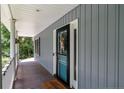 Inviting front porch with a teal door and white columns at 794 Cashmere Ct, Sanford, NC 27332