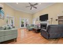 Spacious living room with hardwood floors, fireplace, and access to backyard at 794 Cashmere Ct, Sanford, NC 27332