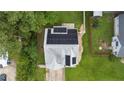 Aerial view of a home with solar panels, surrounded by a well-maintained lawn and mature trees at 60 Hunters Way, Angier, NC 27501