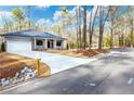 House exterior showcasing a driveway and landscaping at 3011 Bourbon St, Sanford, NC 27332