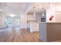 Modern kitchen with white cabinets, island, and hardwood floors at 3011 Bourbon St, Sanford, NC 27332