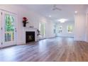 Spacious living room featuring hardwood floors, fireplace, and access to back deck at 3011 Bourbon St, Sanford, NC 27332