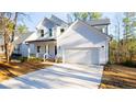 Two-story white house with a two-car garage and front porch at 157 Maplewood Dr, Sanford, NC 27332