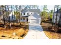 Two-story white house with a two-car garage and driveway at 157 Maplewood Dr, Sanford, NC 27332